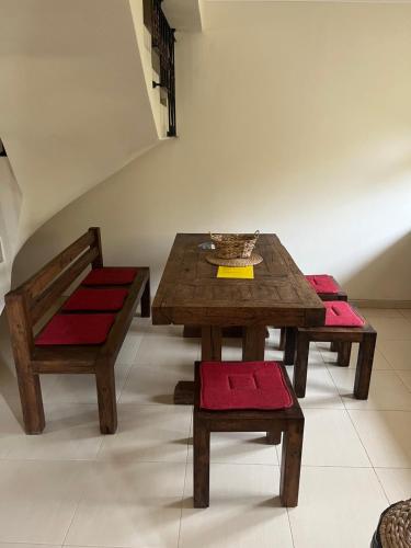 a wooden table and a bench and a table and chair at Къща за гости Геша Вю in Dryanovo