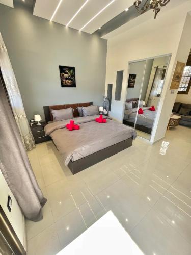 a bedroom with a large bed with red pillows on it at Villa Mira GuestHouse 2 - Downtown Central Amman - AL DIYRIH in Amman