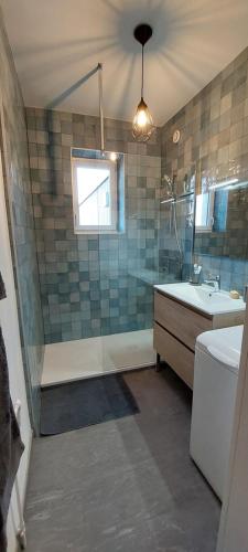 een badkamer met een douche, een bad en een wastafel bij Le Cocon Beaujolais in Châtillon-dʼAzergues