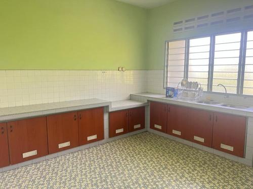 a kitchen with two sinks and a large window at Batu Pahat Airbnb Homestay Empire 9 in Batu Pahat