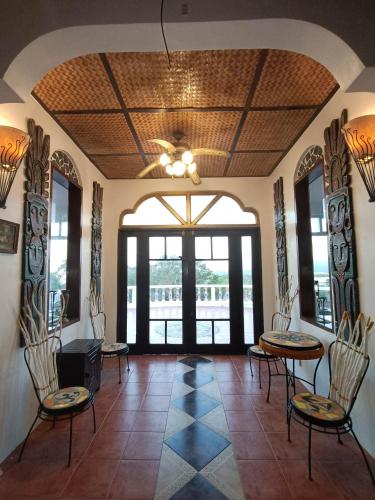 a lobby with tables and chairs and a large window at Casa de Arte in Boracay