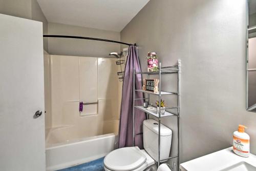 a bathroom with a white toilet and a shower at Fayetteville Vacation Rental with Sunroom and Yard! in Fort Bragg