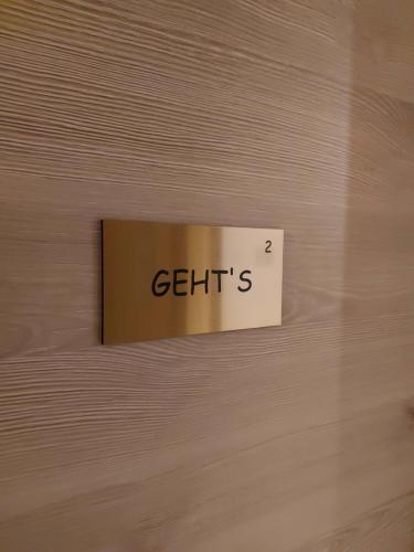 a sign on a wooden wall with the word getts at Mirabelle Bed & Breakfast in Ribeauvillé