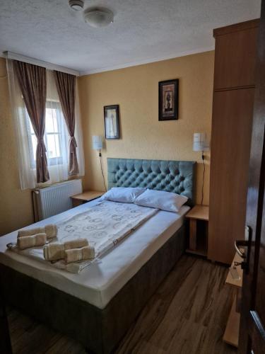 a bedroom with a large bed in a room at Etno kuca sa konacistem GOCKO in Vrnjačka Banja