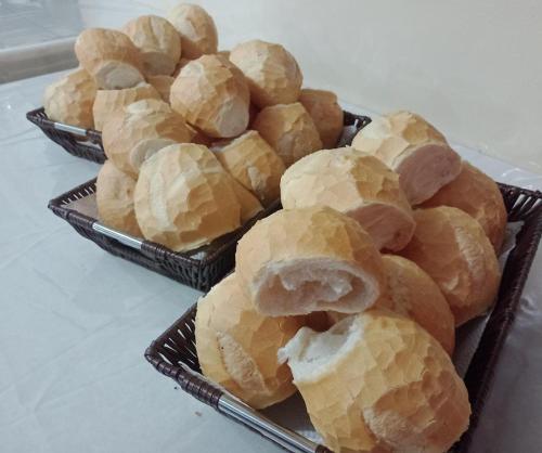 two black baskets filled with pastries on a table at HOTEL NOVO HOTEL in Três Lagoas