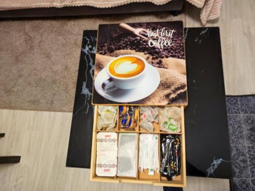 a cup of coffee on a table with a magazine at RESIDENCE SEVIGNE A Disneyland in Coupvray