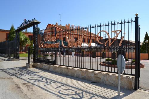 a gate with a sign in front of a building at Hotel Restaurant Sol i Vi in Lavern