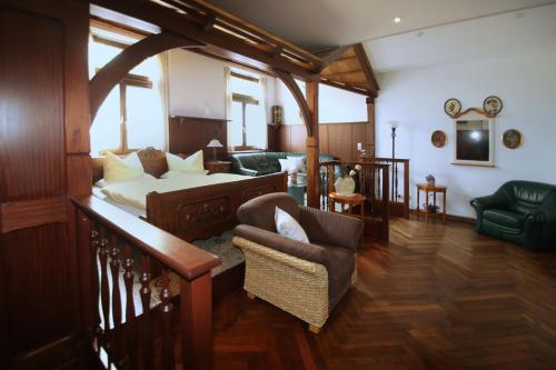 a living room with a bed and a couch at Romantik Landhaus & Pension Klaps Liebling in Lübben