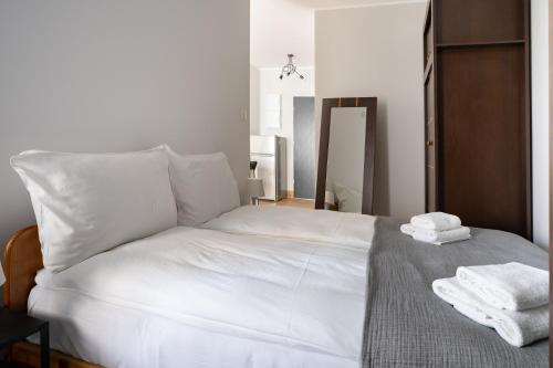 a bedroom with a white bed with towels on it at Baltica Towers by Symphony Aparthotels in Gdańsk