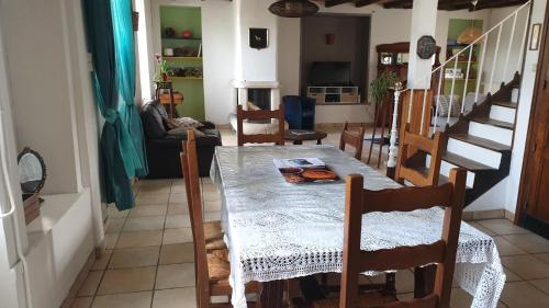 une salle à manger avec une table et quelques chaises dans l'établissement Maison de bourg, à Saint-Maurice-les-Brousses