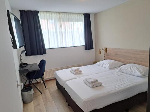 Katil atau katil-katil dalam bilik di Seehotel Oostkapelle