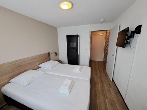 Katil atau katil-katil dalam bilik di Seehotel Oostkapelle