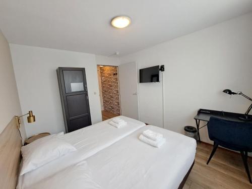 Katil atau katil-katil dalam bilik di Seehotel Oostkapelle