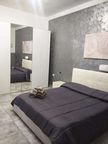 a bedroom with a large bed and a mirror at La Habitacion del Mar in Gallipoli
