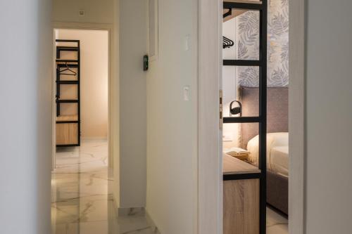 a room with a closet and a bedroom with a bed at Orama Luxury Apartments in Nea Kydonia
