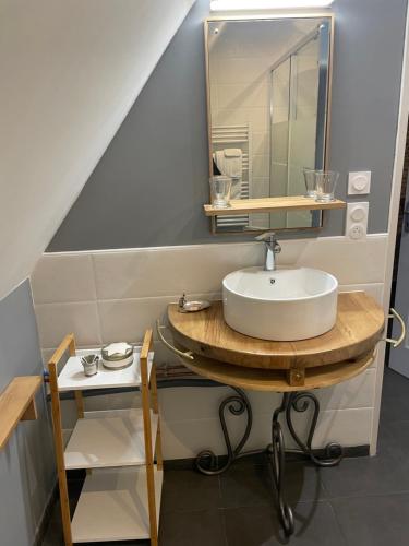 a bathroom with a sink and a mirror at L'Ancien Couvent Cahuzac in Cahuzac