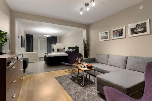 a living room with a couch and a table at Quality Hotel Vänersborg in Vänersborg