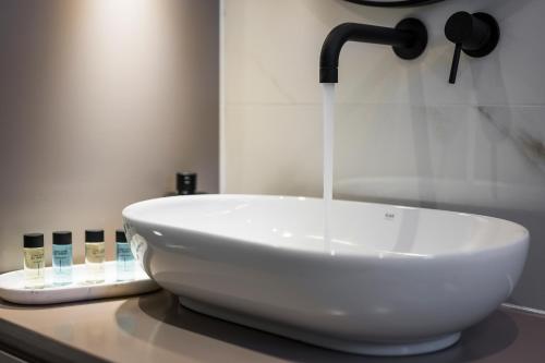 a white sink sitting on top of a counter at Orama Luxury Apartments in Nea Kydonia