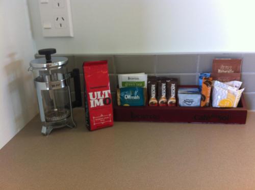 a shelf in a room with a blender and books at Darfield Motel in Darfield