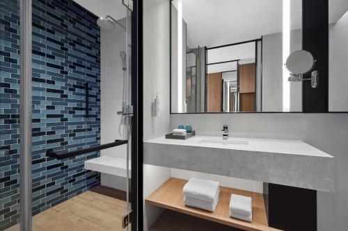 a bathroom with a sink and a mirror at Fairfield by Marriott Changzhou Jintan in Changzhou