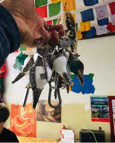 a person is holding a bunch of metal objects at Yog Hostel- Rooftop Yoga & Backpacker Social Stay in Thamel, Kathamndu in Kathmandu