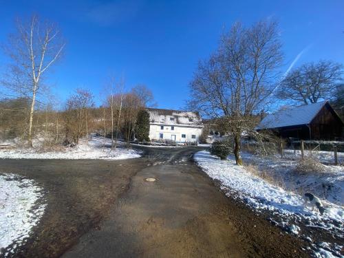 a road in front of a house in the snow at Urlaub in der Natur in Lüdenscheid