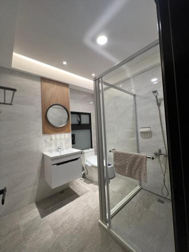 a bathroom with a toilet and a sink and a shower at Traveler's Campfire B&B in Magong