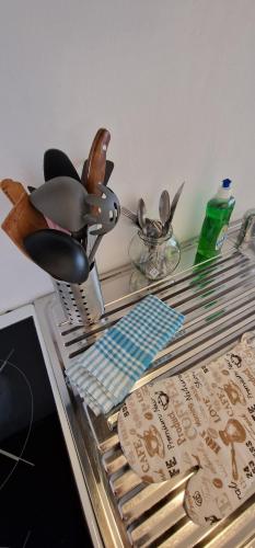 a glass table with utensils on top at Apartman MURKO P-1 