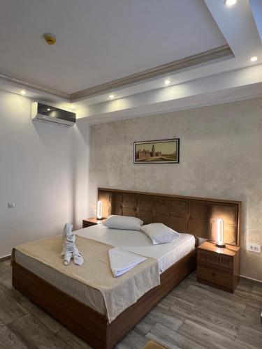 a bedroom with a large bed and two night stands at Hotel EKA in Constanţa