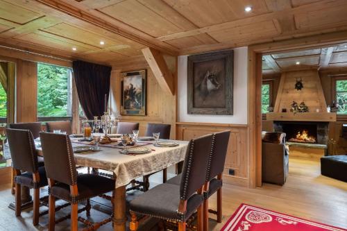 a dining room with a table and chairs and a fireplace at Beautiful Nirvana in Megève