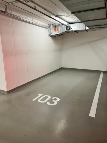 a parking garage with a no parking sign on the floor at White Pearl Studio with parking in Holešovice in Prague