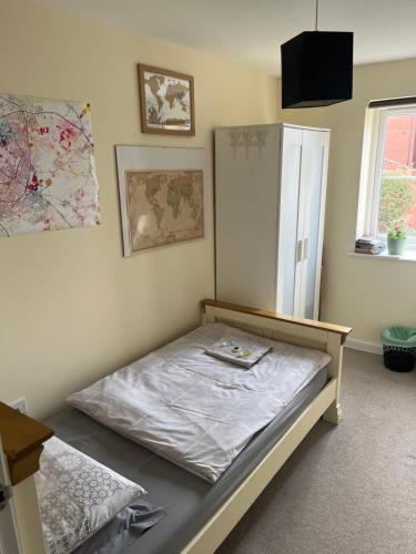 a bedroom with a bed and a cabinet in it at Cozy Room in Oxford
