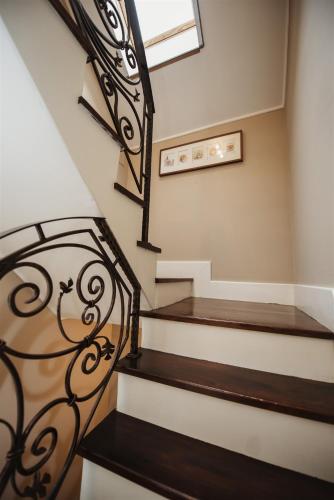 a set of stairs with a wrought iron railing at Hilltop Wellness Villa-big garden, sauna, hot tube in Pécs