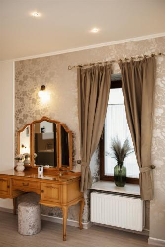 a bathroom with a vanity and a mirror and a window at Hilltop Wellness Villa-big garden, sauna, hot tube in Pécs