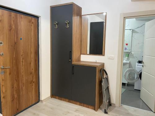 a bathroom with a black door and a mirror at Ulcinj Apartments in Ulcinj