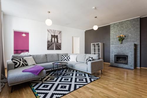 a living room with a couch and a fireplace at Old Town - Viru Apartment in Tallinn