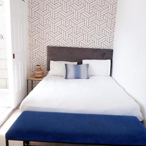 a bedroom with a large bed with a blue blanket at The City Club in Cape Town