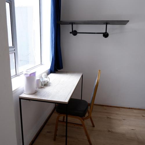 a desk with a chair next to a window at The City Club in Cape Town