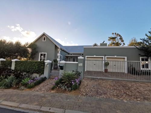 a house with a white picket fence at Huis van Brood Guesthouse in Malmesbury