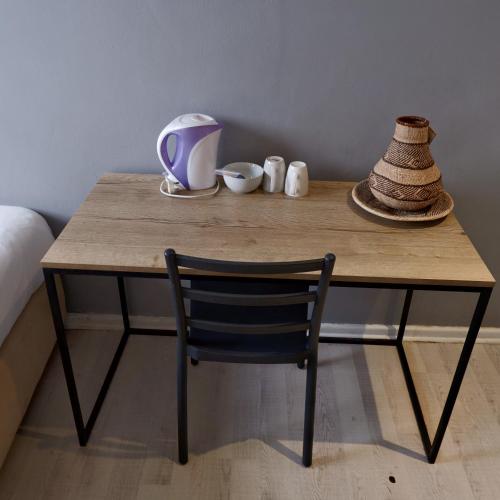 a wooden table with a chair in a room at The City Club in Cape Town