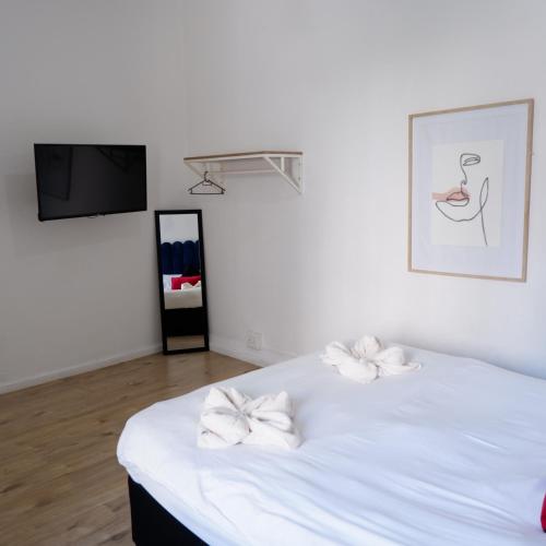 a bedroom with a white bed with white bows on it at The City Club in Cape Town
