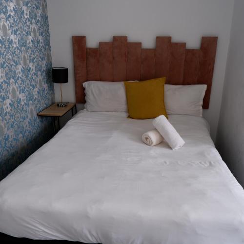 a bed with two towels on top of it at The City Club in Cape Town