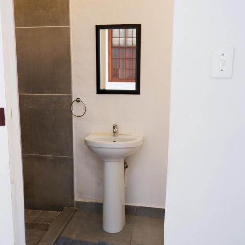 a bathroom with a sink and a mirror at The City Club in Cape Town
