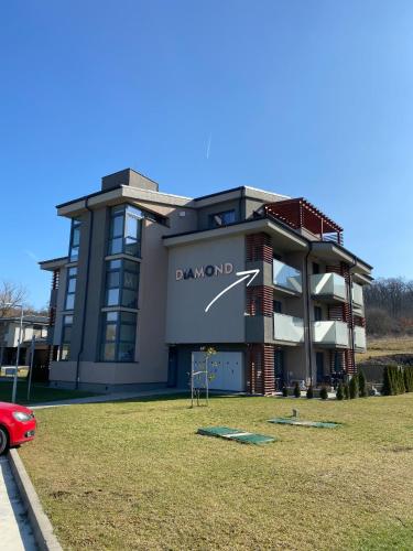 a building with a playground in front of it at Apartmány Meghan in Podhájska