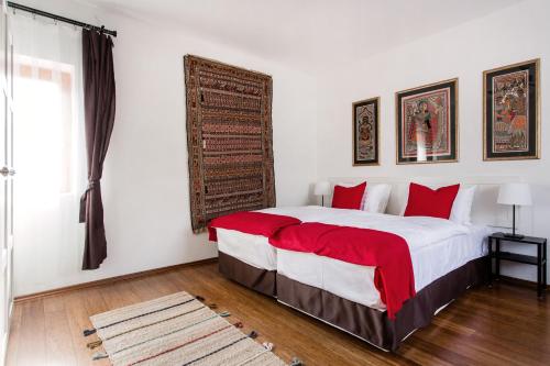 a bedroom with a large bed with red pillows at Cecile's Central, Gastro str, WIFI, 2 bed and 2 bathrooms in Budapest