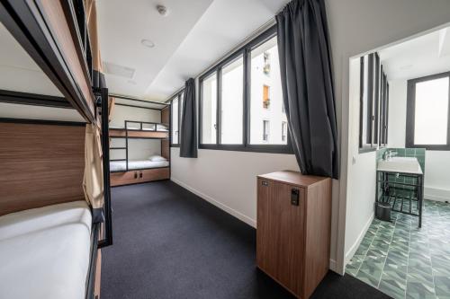 a small room with a bed and a sink in it at Beau M Paris in Paris