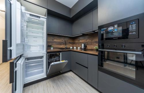 a kitchen with an open refrigerator and a stove at Люкс на Бориспільській ЖК Олімпік Парк, генератор на будинку in Kyiv