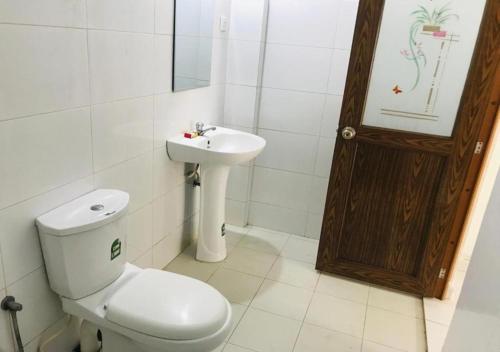 a bathroom with a toilet and a sink at Villa 64 in Katunayake