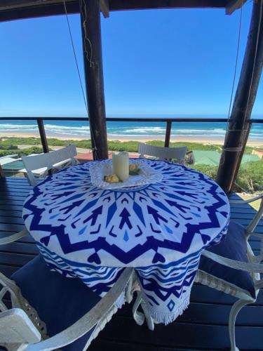 a blue and white table with a candle on a balcony at Pienaars Guesthouse in Groot Brak Rivier