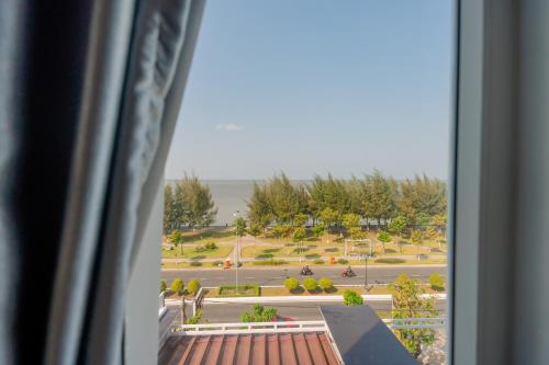 a view of a park from a window at LÊ ĐOÀN HOTEL in Rach Gia